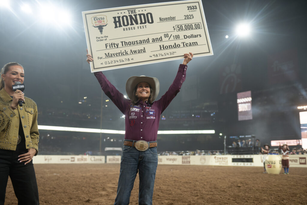 Lisa Lockhart holds up a massive check