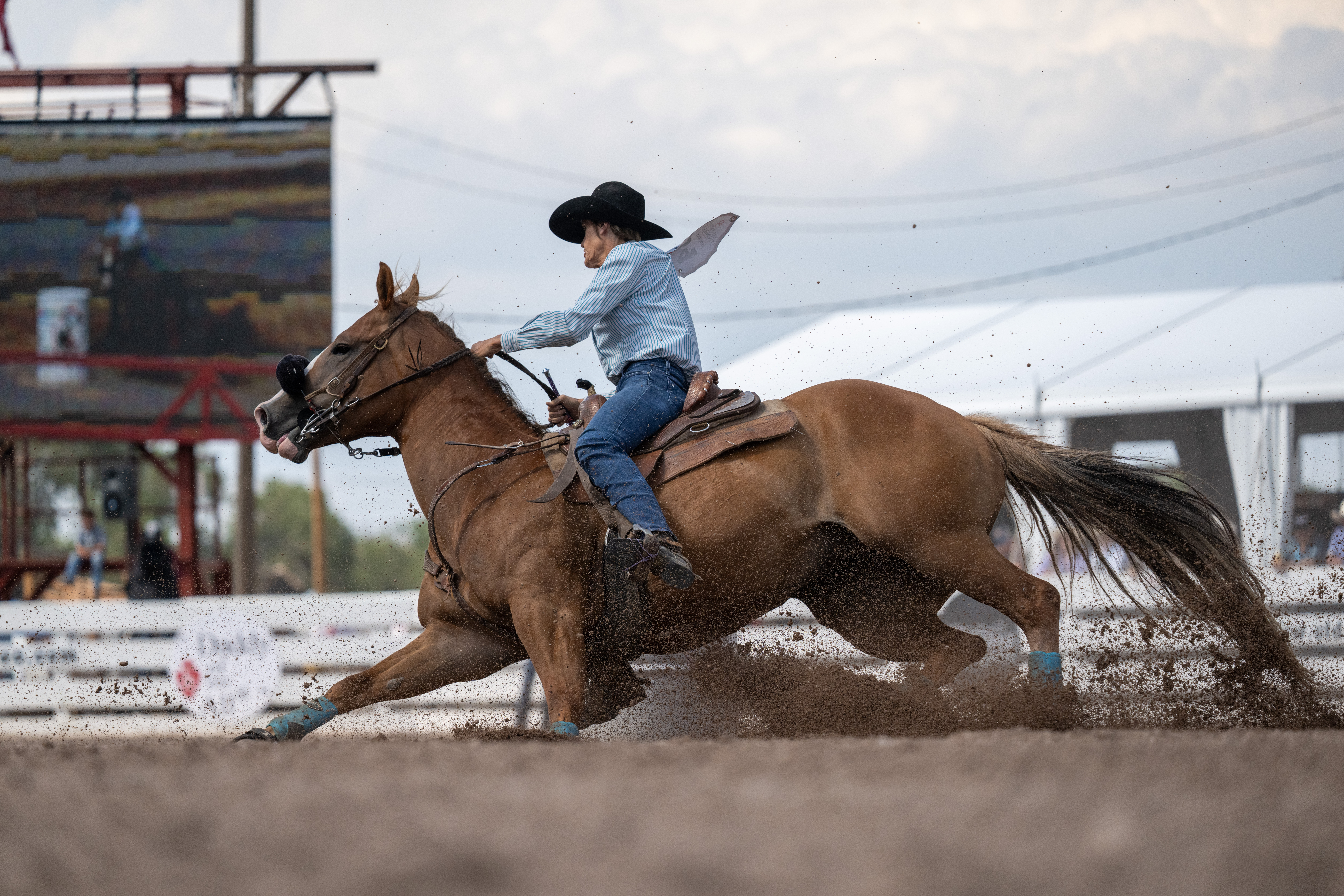 Kim Squires turns a barrel on her red horse